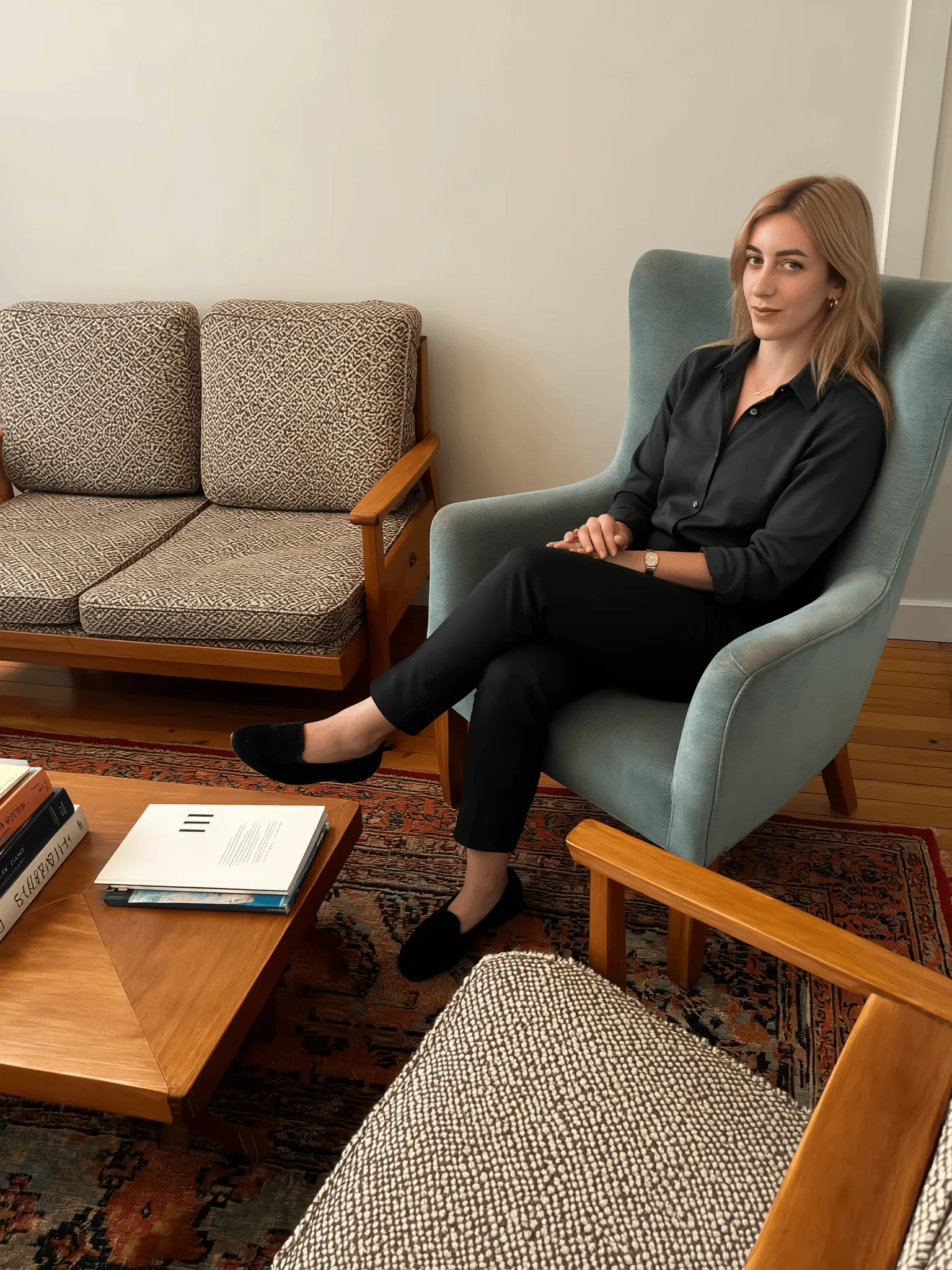 Aristea Kontokosta, psychotherapist, smiling in her bright, modern office